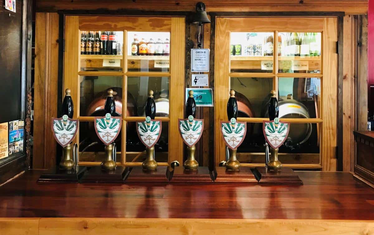 Brass beer taps and warm wooden bar inside 3 Legged Crane Pub and Brewhouse in Oakridge Oregon