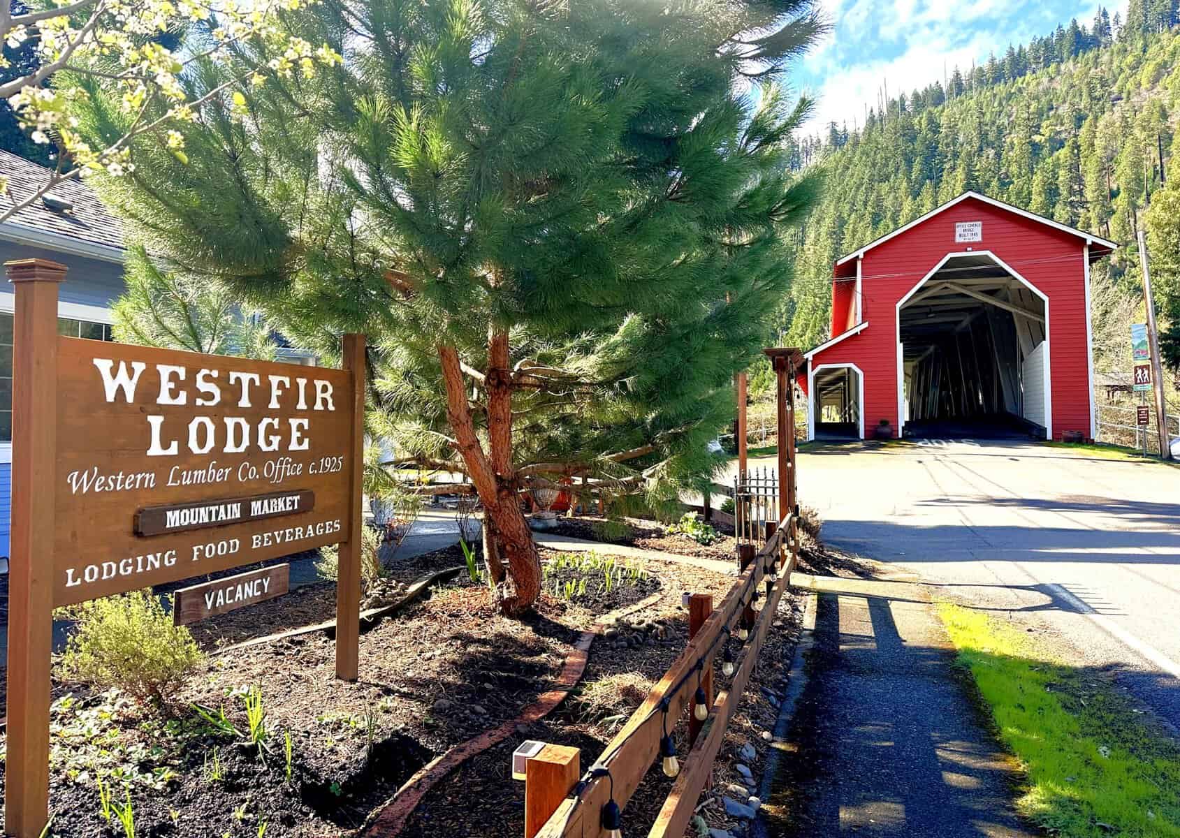 Wooden Westfir Lodge sign surrounded by trees outside the historic lodge in Westfir Oregon