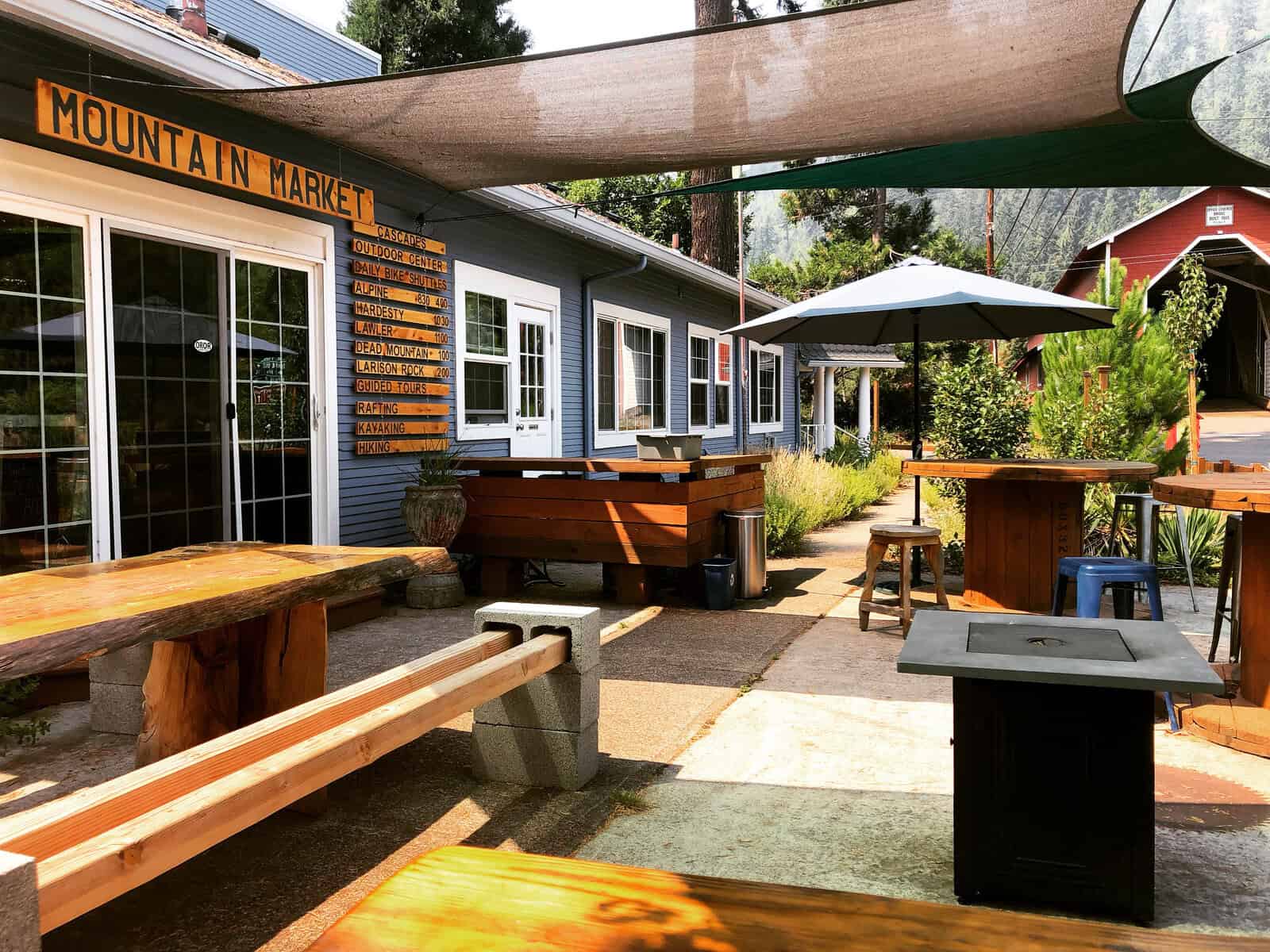 Mountain Market entrance and outdoor wooden tables at historic Westfir Lodge in Oregon