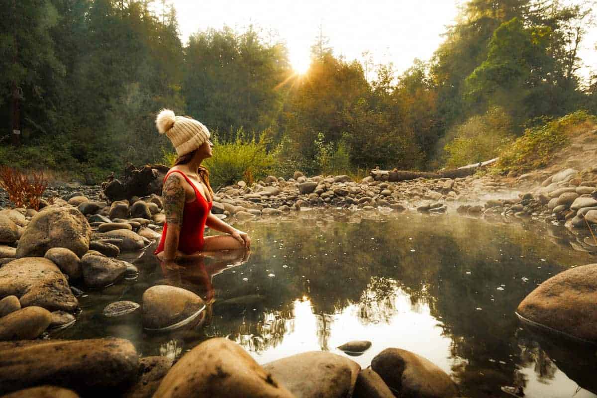 Person soaking in a naturally heated rocky pool at McCredie Hot Springs near Oakridge Oregon