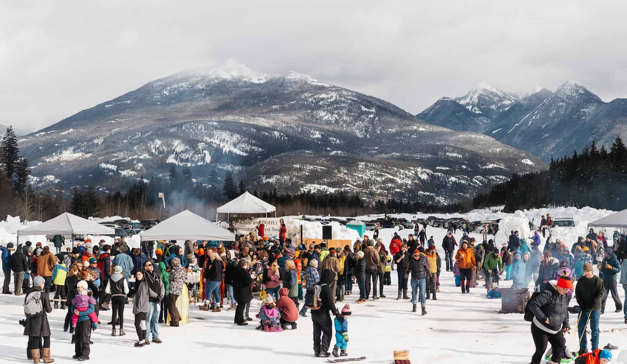 Kaslo Winter in the Forest Festival with families enjoying outdoor winter activities and snow-covered mountain scenery
